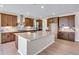 Spacious kitchen boasts a large island, stainless steel appliances, stylish backsplash, and wooden floors at 3422 N Gold Bug Ct, Aurora, CO 80019