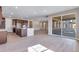 Spacious open floor plan combines the kitchen and living area with a sliding glass patio door at 3422 N Gold Bug Ct, Aurora, CO 80019