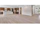 An open-concept living room connects to the kitchen with beautiful flooring and natural light at 3422 N Gold Bug Ct, Aurora, CO 80019