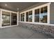Covered patio with stone accents and sliding glass door looks into the home at 3422 N Gold Bug Ct, Aurora, CO 80019