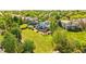 Aerial view showcasing a home with a large backyard, deck, and solar panels amidst a lush, green neighborhood at 3715 E 139Th Pl, Thornton, CO 80602