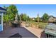 Large wooden deck featuring dining set with views of the landscaped backyard at 3715 E 139Th Pl, Thornton, CO 80602