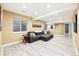 Finished basement with a comfortable seating area, neutral walls and wood-look floors at 3715 E 139Th Pl, Thornton, CO 80602