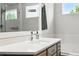 Bright bathroom showcasing a well-lit mirror, white countertops, and neutral decor at 3715 E 139Th Pl, Thornton, CO 80602