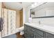 Modern bathroom features tile shower and a vanity with gray cabinets at 3715 E 139Th Pl, Thornton, CO 80602