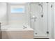 Bathroom features a soaking tub and separate shower with modern fixtures at 3715 E 139Th Pl, Thornton, CO 80602