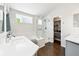 Bright bathroom with soaking tub, walk-in shower, double vanity, and spacious walk-in closet at 3715 E 139Th Pl, Thornton, CO 80602