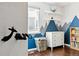 Charming bedroom displays custom mountain accent wall, hardwood floors, and playful decor at 3715 E 139Th Pl, Thornton, CO 80602