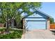 Charming light blue home featuring a two-car garage, well-maintained lawn, and inviting curb appeal at 3715 E 139Th Pl, Thornton, CO 80602