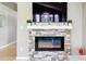 Stone fireplace with mounted tv and decor in the living room at 3715 E 139Th Pl, Thornton, CO 80602