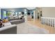 Open concept living and dining area with hardwood floors and gray sofa at 3715 E 139Th Pl, Thornton, CO 80602