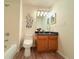 Bright bathroom featuring stylish vanity, decorative wall art, wood-look vinyl flooring, and tub with shower at 94 Vale St, Palmer Lake, CO 80133