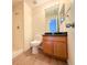 Bathroom with wood-look flooring, vanity with wood cabinets, and step-in shower at 94 Vale St, Palmer Lake, CO 80133