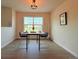 Dining area with modern table, seating for two, large window, and stylish light fixture at 94 Vale St, Palmer Lake, CO 80133