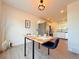 Dining room with table set for two, modern lighting fixture, and easy access to kitchen at 94 Vale St, Palmer Lake, CO 80133