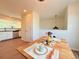 Dining room showcasing table set for two, seamlessly connecting to kitchen with modern lighting at 94 Vale St, Palmer Lake, CO 80133