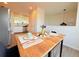 Dining table set for two, with bright natural light, open concept adjacent to kitchen at 94 Vale St, Palmer Lake, CO 80133