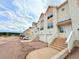 Exterior view of townhomes with attached garages, and stairways leading to front entryways at 94 Vale St, Palmer Lake, CO 80133