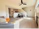 Living area featuring sleek ceiling fan, and an open design to the kitchen at 94 Vale St, Palmer Lake, CO 80133