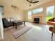 Bright living room with fireplace, fan and big windows at 94 Vale St, Palmer Lake, CO 80133