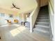 Bright living room with hardwood floors, stairs to second level, and two accent chairs at 94 Vale St, Palmer Lake, CO 80133