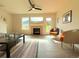 Bright, airy living room with a fireplace, laminate flooring, and access to the outdoors at 94 Vale St, Palmer Lake, CO 80133