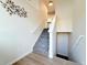 View of staircase with neutral walls, carpeted steps, and wood flooring at 94 Vale St, Palmer Lake, CO 80133