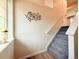 Staircase leading to upper level with decorative wall decor, neutral paint and wood-look floors at 94 Vale St, Palmer Lake, CO 80133