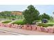 Street view of property with well manicured lawn area and large decorative rock border at 94 Vale St, Palmer Lake, CO 80133