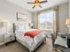 Cozy bedroom with a ceiling fan, a large window, and neutral decor at 11621 Colony Loop, Parker, CO 80138