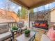 Relaxing covered patio with comfortable seating and a decorative privacy screen at 11621 Colony Loop, Parker, CO 80138