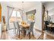 Elegant dining room featuring a chandelier, marble table, and large windows for natural light and an outdoor view at 11621 Colony Loop, Parker, CO 80138