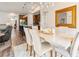 Open-concept dining area with a chandelier, a large mirror, and a view into the modern kitchen with an island at 11621 Colony Loop, Parker, CO 80138