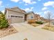 Charming home featuring a two-car garage, stone accents, and a well-maintained front yard at 11621 Colony Loop, Parker, CO 80138