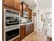 Kitchen featuring stainless steel double ovens, cooktop and microwave, with wood cabinets and countertop space at 11621 Colony Loop, Parker, CO 80138