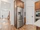 Modern kitchen with stainless steel appliances, wood cabinets, and hardwood floors at 11621 Colony Loop, Parker, CO 80138