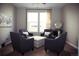 Inviting living room with four dark gray chairs and a decorative mirror at 11621 Colony Loop, Parker, CO 80138