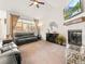 Comfortable living room with a fireplace, TV, and large windows, creating an inviting space for relaxation and entertainment at 11621 Colony Loop, Parker, CO 80138