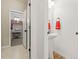 Bright powder room featuring a pedestal sink, red towel and open access to the walk-in closet at 11621 Colony Loop, Parker, CO 80138