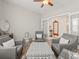 Cozy sitting room featuring elegant gray armchairs and a geometric patterned ottoman, perfect for relaxation at 11621 Colony Loop, Parker, CO 80138