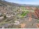 Stunning aerial view of a golf course, rock formations, and luxury homes at 5688 Red Fern Ct, Littleton, CO 80125