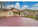 Backyard with patio, stamped concrete and view of the surrounding hills at 5688 Red Fern Ct, Littleton, CO 80125