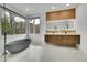 Bright bathroom with a soaking tub, double vanity, and view to the outside at 5688 Red Fern Ct, Littleton, CO 80125