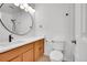 Modern bathroom with a single vanity, toilet, and updated lighting fixtures at 5688 Red Fern Ct, Littleton, CO 80125