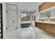Bright bathroom with a glass shower, soaking tub, double vanity, and large window at 5688 Red Fern Ct, Littleton, CO 80125