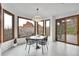 Bright dining area with modern furniture and expansive windows showcasing stunning red rock views at 5688 Red Fern Ct, Littleton, CO 80125
