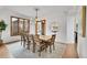 Stylish dining room with modern chandelier, sleek furniture and large windows for ample natural light at 5688 Red Fern Ct, Littleton, CO 80125