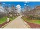 Long driveway leads to an impressive home with mature trees and lush landscaping at 5688 Red Fern Ct, Littleton, CO 80125
