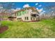 Exterior of home with large green lawn, sauna, and upper-level deck at 5688 Red Fern Ct, Littleton, CO 80125
