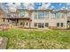 Backyard with large grass area, stone wall, upper deck and hot tub at 5688 Red Fern Ct, Littleton, CO 80125